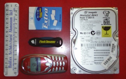 Drive next to a ruler, phone, box of chewing gum and a HDD, it's the smallest.