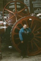Little me standing in front of a BIG wheel.